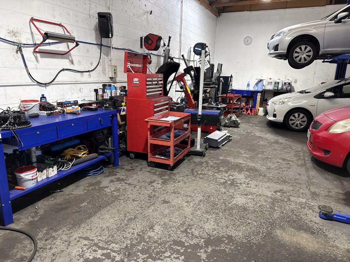 The 99 Automobiles workshop floor with tools and vehicles on the hoist