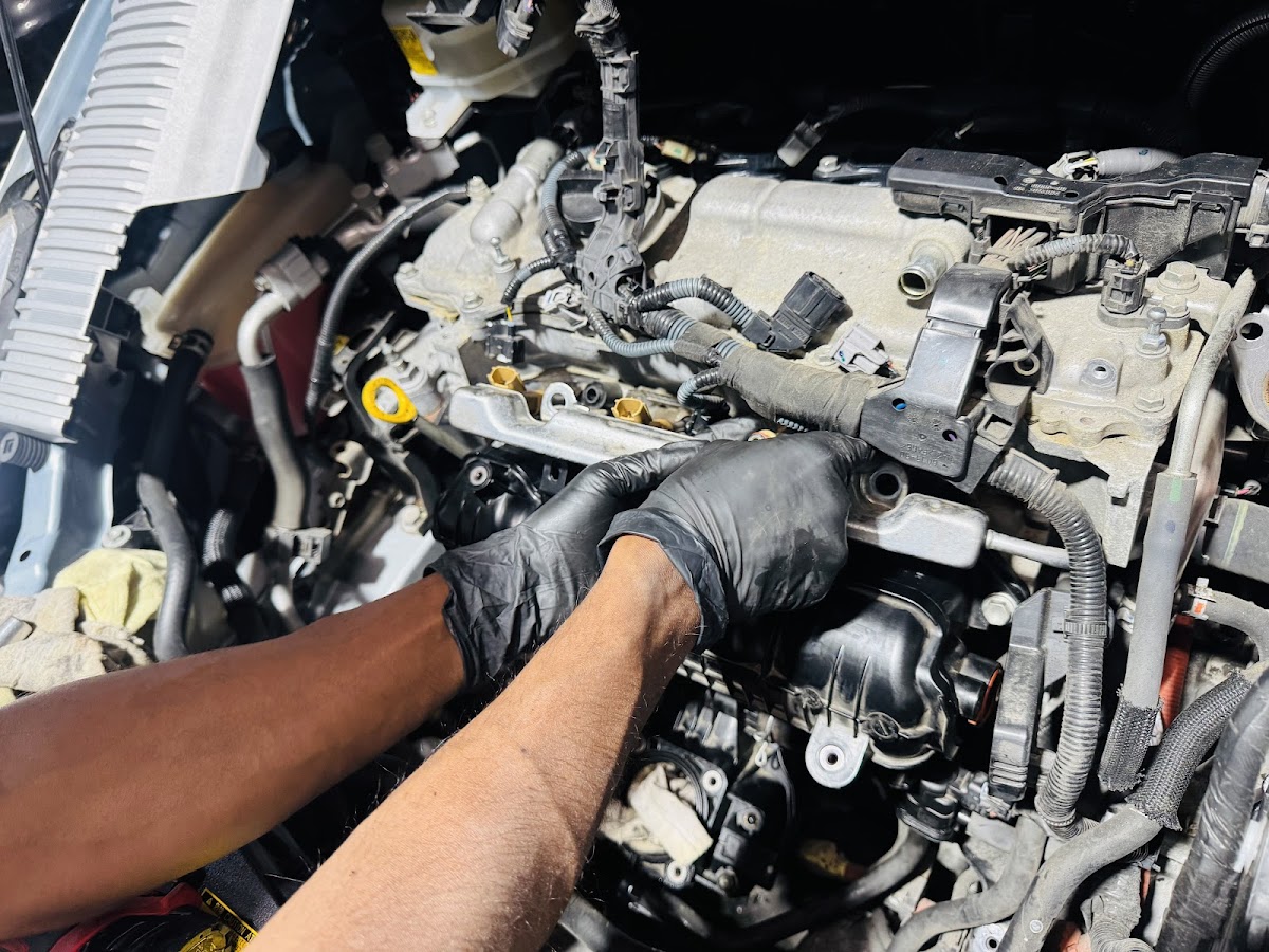 Close-up of a mechanic working inside an engine bay